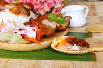 Fried chicken rice with sauces and vegetable salad