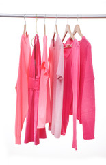 row of pink shirt on a hanger –on white background