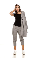 surprised young beautiful woman in a jacket, blouse and trousers