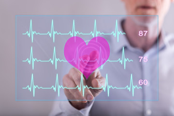 Man touching a heart beats graph concept on a touch screen