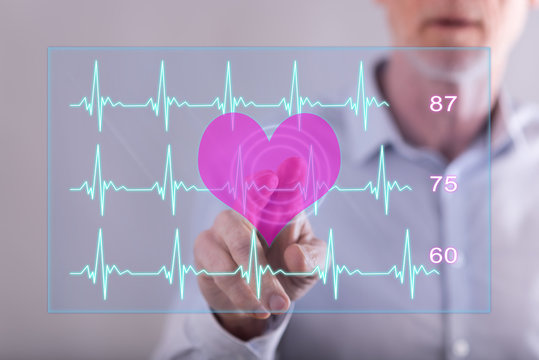 Man touching a heart beats graph concept on a touch screen