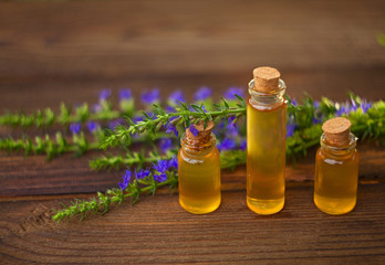 essential oil on table in beautiful bottle with flowers
