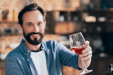 man holding wine glass