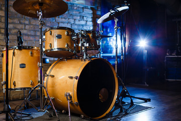 Modern drum set shot in smoky dark studio