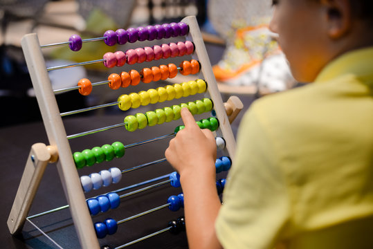 Close up on colorful abacus playful activity, educational interior background. Happy joyful developmental lifestyle