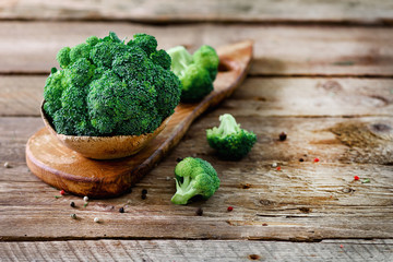 Fresh organic broccoli on wooden table close up with copyspace