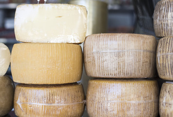 Different types of cheeses for sale to a market in Italy, typical product.
