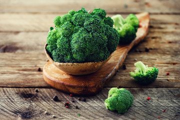 Fresh organic broccoli on wooden table close up with copyspace