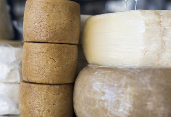 Different types of cheeses for sale to a market in Italy, typical product.