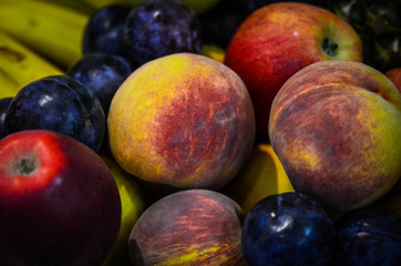 fresh fruits close up - grapes, peach, kiwi, pomegranate, plums, oranges