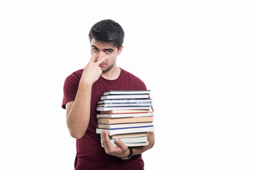 Student holding pile of books showing look into eyes