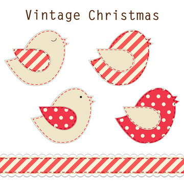 Cute fabric paradise birds as retro fabric applique in shabby chic style in traditional Christmas colors