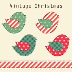 Cute fabric paradise birds as retro fabric applique in shabby chic style in traditional Christmas colors