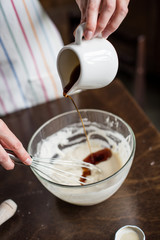 woman adding honey into bowl