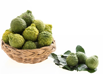 Kaffir lime,Bergomot in bamboo tray isolated on white background,Hair spa treatment and food ingredient