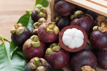 Fresh Mangosteen fruits on wood table top ,queen of fruit in Thailand