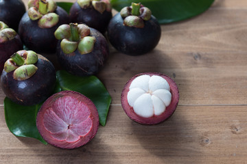 Fresh Mangosteen fruits on wood table top ,queen of fruit in Thailand