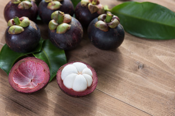 Fresh Mangosteen fruits on wood table top ,queen of fruit in Thailand