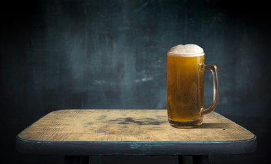 Beer barrel with glasses on table wooden background