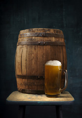 Beer barrel with glasses on table wooden background