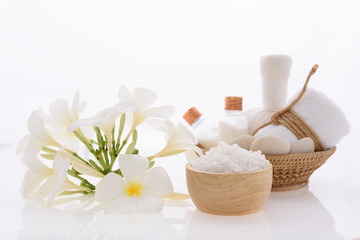 Fototapeta na wymiar Bath products and skincare treatment with Plumeria spa flower on white background