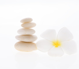 Fototapeta na wymiar Pile of zen stones and Frangipani flower isolated on white background