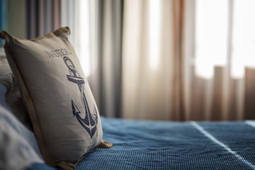 Holiday summertime travel concept - small toy pillow with anchor © Todor Rusinov