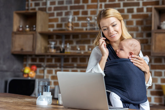 businesswoman with baby in hands