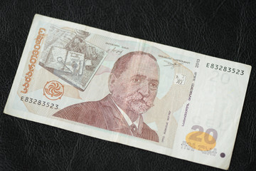 Georgian banknote in twenty lari on a dark background close up
