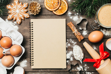 Xmas baking or cooking background. Ingredients, kitchen items for baking cookies. Kitchen utensils, flour, eggs and sugar. Text space, top view.