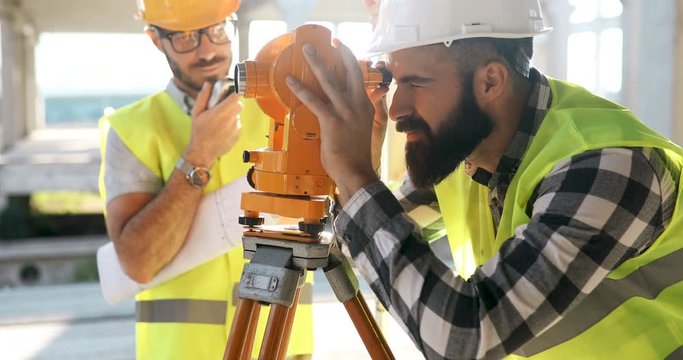 Portrait of construction engineers working on building site - Powered by Adobe