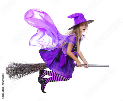 Pretty girl wearing witch halloween dress flying on a broom