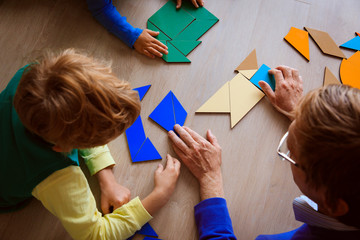 teacher and kids playing with geometric shapes - 172986983