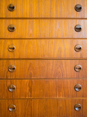 closeup vintage wooden handle on old brown wood drawer