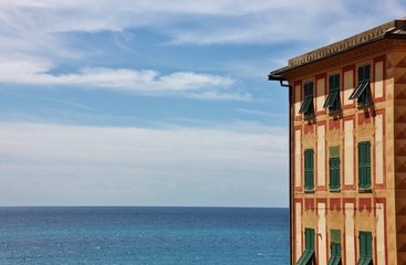 Old colorful building in Boccadasse with sea view, Liguria, italy  - obrazy, fototapety, plakaty