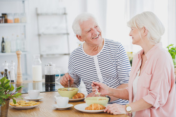 Woman in pink shirt is eating milk soup