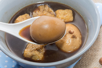 Eggs boiled stewed in the gravy on white background