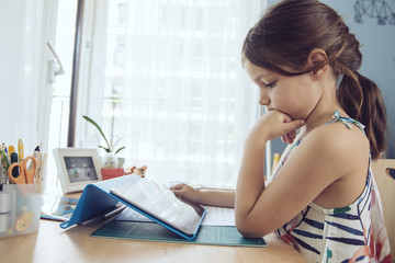 Girl using tablet at home
