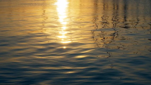 golden evening sunlight reflections on water