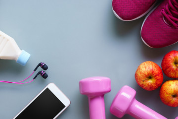 Fitness and healthy active lifestyle background concept. Dumbbell, sneakers,  milk bottle, apples,...