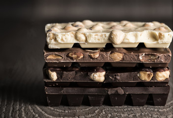 Milk and dark chocolate on a wooden table