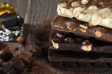 Milk and dark chocolate on a wooden table