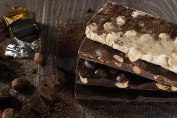 Milk and dark chocolate on a wooden table
