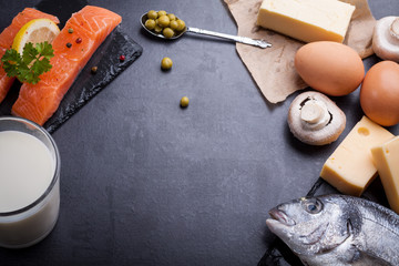 Black table with ingredients of food rich in vitamin D and omega 3, with copy space.