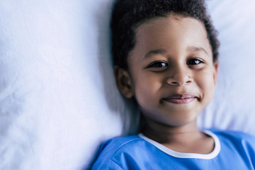 african american boy lying in bed