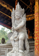 Fototapeta na wymiar Decorated statue of traditional hindu god, at Ganung Kawi Temple, Bali, Indonesia