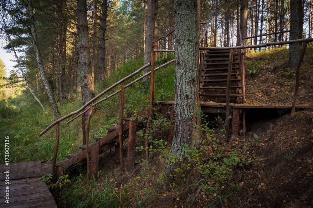 Poster wooden staircase leading to the water