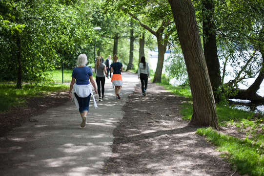 Powerful happy elderly people are walking, running in the park