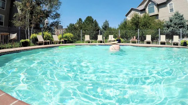 POV point of view - Mother and daughter swimming in outdoor swimming pool