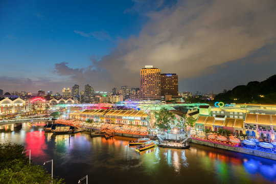 Colorful light building at night in Clarke Quay, Singapore. Clarke Quay, is a historical riverside quay in Singapore.
